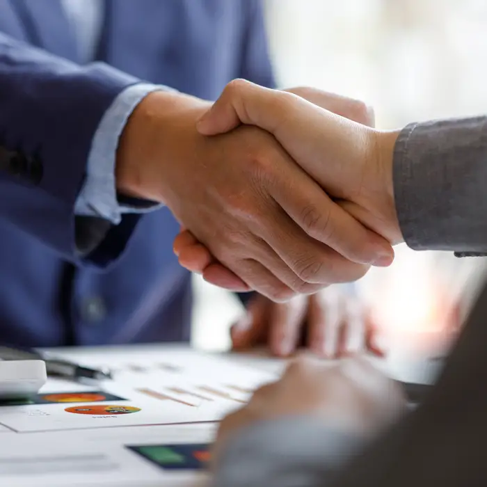 IMG-partnership1-c590 Business partners shaking hands at an office
