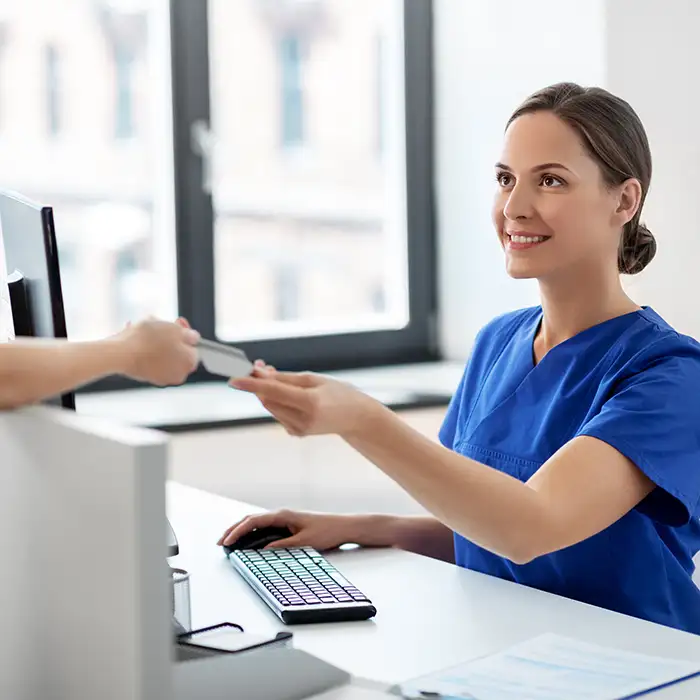 Healthcare staff accepting card from customer Healthcare staff accepting card from customer